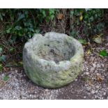 An ancient Yorkshire roughly hewn fossil stone mortar with a later hole drilled for use as a
