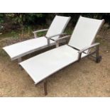 A pair of teak adjustable sun loungers, with white net fabric and arm rests, 62cm wide x 191cm