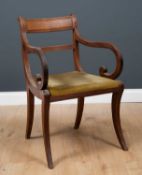 A Regency mahogany carver armchair with bar back and reeded ornament to the arms and sabre legs,