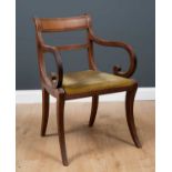 A Regency mahogany carver armchair with bar back and reeded ornament to the arms and sabre legs,
