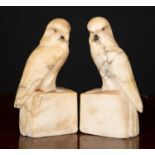 A pair of carved alabaster parrot bookends with beaded eyes, 7cm wide x 5.5cm deep x 16.5cm high, (