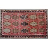 An antique Kelim carpet with fifteen central octagonal motifs, 339cm x 239cmCondition report: