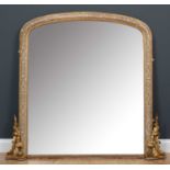 A gilt and white painted arch-topped overmantle mirror, the frame decorated with interlocking