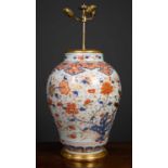 An antique porcelain large baluster jar converted to a table lamp, in imari colors, the white ground