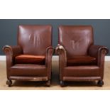 A pair of brown leather armchairs, the upholstered arms and seat backs with brown velvet upholstered