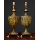 A pair of bronzed table lamps formed as classical urns with fluted sides, on square bases and paw