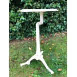 A Victorian white painted cast iron tripod table, the rectangular top supported by shaped and fluted