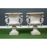 A pair of Victorian white-painted cast iron urns, with scrolling handles and carved decoration to