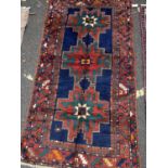 A Russian Kazakh red, blue and green ground rug, with three central cross motifs, 237cm x