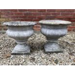 A pair of concrete urns, each approximately 40cm diameter x 39cm high (2).Condition report: A couple