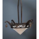 A wrought iron and frosted glass ceiling light in the manner of Edgar Brandt, with four scrolling