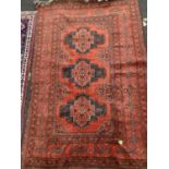 A Belouchi style red ground rug 200cm x 124cm and an Eastern polychrome rug, 123cm x