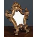 A gold painted embellished shield shaped oak framed table top mirror with stand, 38cm wide x 47cm