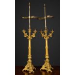 A pair of table lamps constructed from ormolu candlesticks with three scrolling branches and cast