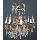 A hanging eight light electrolier or chandelier with acanthus leaf moulded branches and cut glass