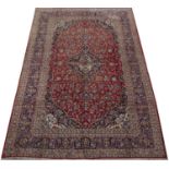 An Eastern red, blue and green ground carpet with stylised decoration, 362cm x 252cmCondition