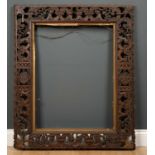 A 19th century Anglo-Indian hardwood frame, extensively carved with a frieze of animals amongst