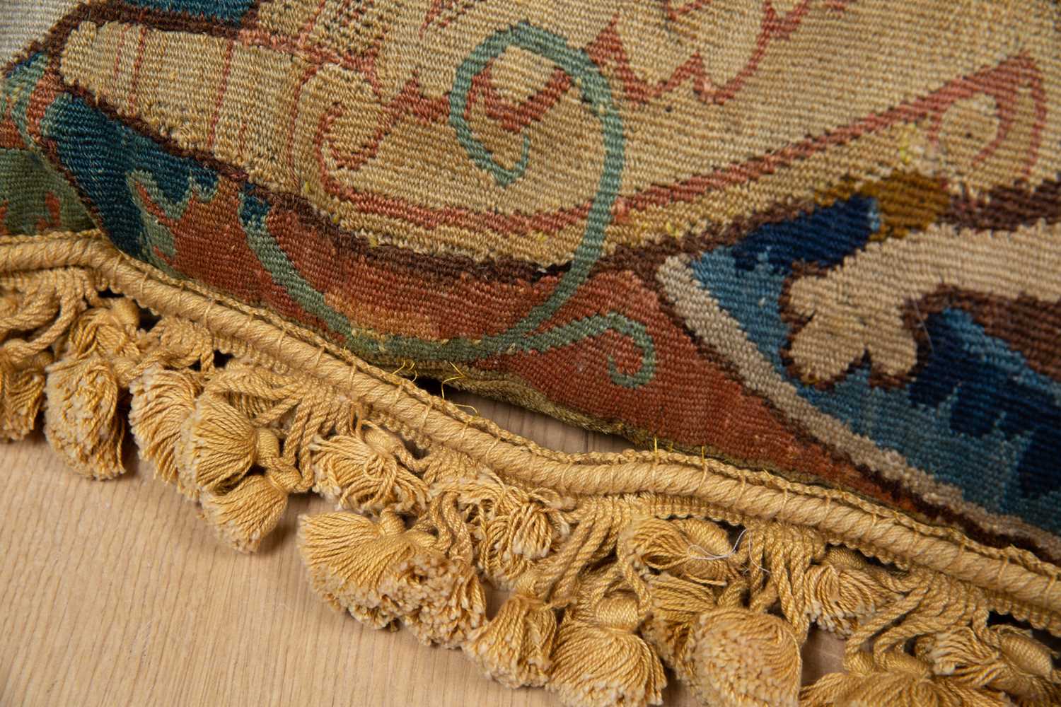 A pair of 17th century tapestry fragments used as cushions, each decorated with bearded masks and - Image 3 of 3