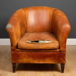 A contemporary leather tub armchair with squab cushion, with a label to the seat, and standing on