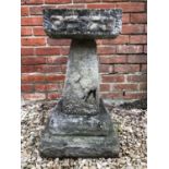 A square concrete bird bath with moulded edges on tapered square pillar and plinth base, bath 32cm