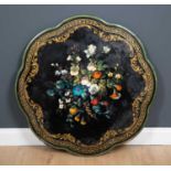 A 19th century scalloped edge circular black lacquer table top with painted and mother-of-pearl