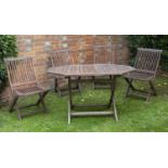 A Kent teak folding garden table and four chairs in good condition with some minor marks and wear