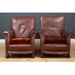 A pair of brown leather armchairs, the upholstered arms and seat backs with brown velvet upholstered