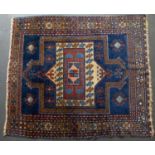 An early to mid 20th century Middle Eastern woollen blue and red ground rug with a multiple banded