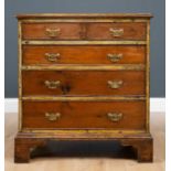 A 19th century small sized pine chest of four long graduated drawers all standing on bracket feet,