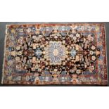 A mid to late 20th century Middle Eastern polychrome rug with a central star motif and stylised