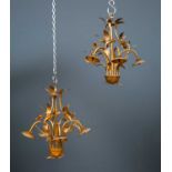 A pair of gold painted hanging light fittings with five lights and decorative leaf ornament, each