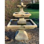 A square section three-tier reconstituted stone fountain, of modern manufacture, 96cm wide x 154cm
