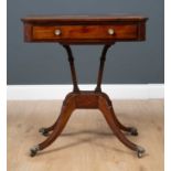 A George III mahogany reading table the rectangular tilting top with canted corners and ebony