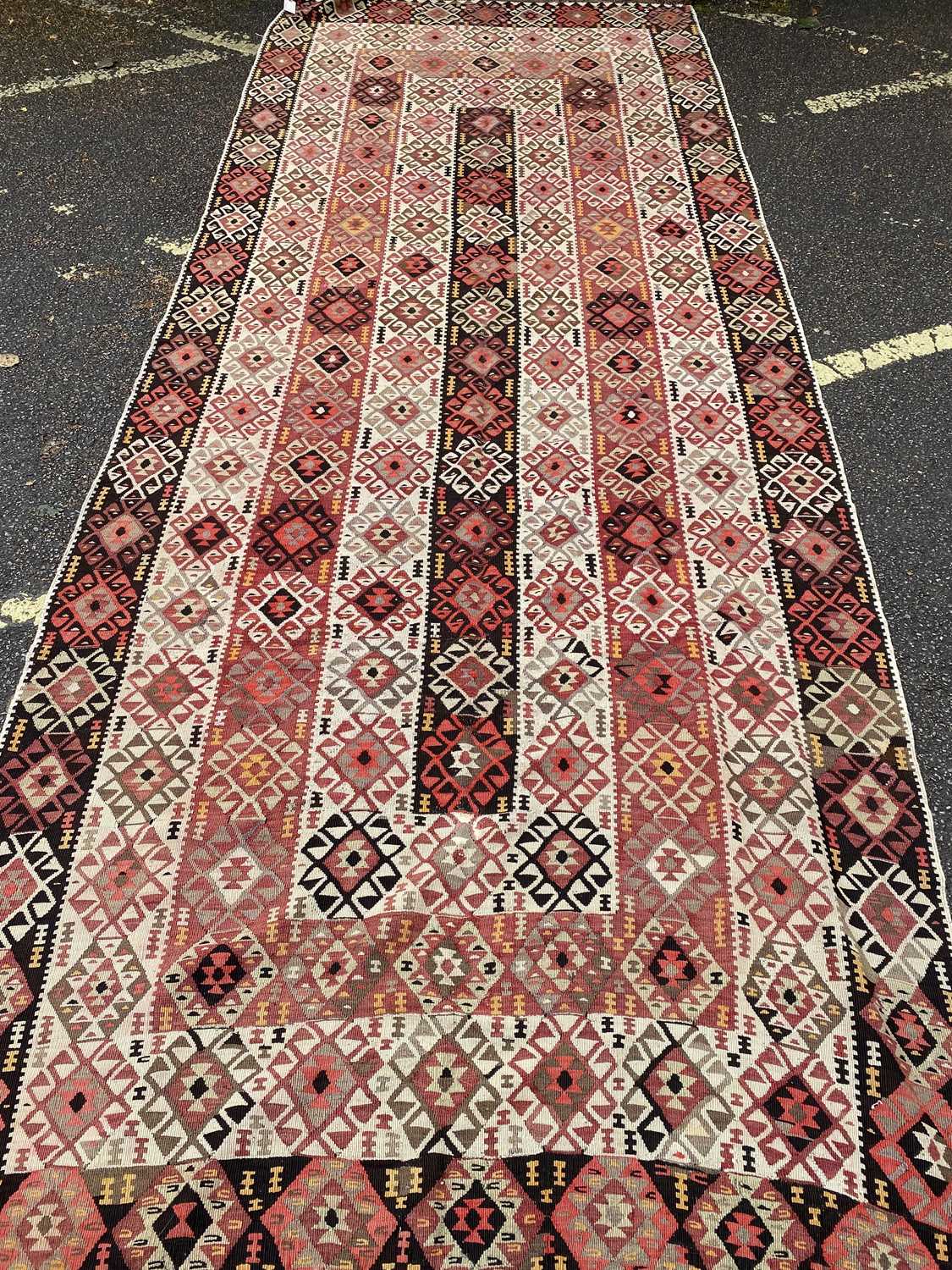 An early 20th century Kelim rug in green, red and orange, 152cm x 390cmCondition report: In moderate