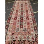 An early 20th century Kelim rug in green, red and orange, 152cm x 390cmCondition report: In moderate
