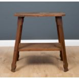 A Liberty and Co. octagonal oak side table, on four outswept supports united by perimeter stretcher,