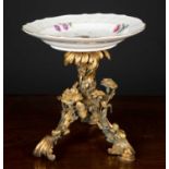 An 18th century Meissen plate on 19th century ormolu stand, the plate with textured scalloped