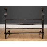 An 18th century or earlier wrought iron fire grate, the dogs to either side with circular finials