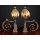 A pair of Victorian brass and steel art nouveau andirons the finials in the form of stylised seed