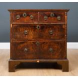 An early 18th century and later small sized chest of two short and two long drawers with brass