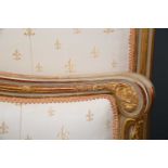 A giltwood king sized bed with upholstered ends and turned feet, overall 182cm wide x 156cm high