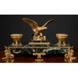 A gilt metal mounted black marble desk stand, the central eagle surmount on pedestal and flanked