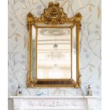 A 19th century style giltwood cushion framed mirror, the bevelled rectangular mirror plate sat in a