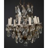 A French nine-light chandelier, with four layers of hanging glass pendants on central glass turned