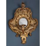 An antique, possibly 18th century, Venetian carved and giltwood girandole mirror, the shaped