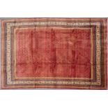 A Middle Eastern Araak woollen rug with a banded border and geometric decoration, 320cm x