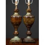 A pair of bronzed table lamps formed as classical urns with fluted shoulder and foot, on square