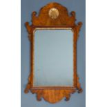 A Georgian style walnut fret framed wall mirror with carved gilt shell ornament to the cresting,