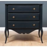 A dark grey painted chest of three drawers with shaped apron and square tapering cabriole legs to