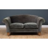 A contemporary two seater grey upholstered sofa with turned tapering oak front legs, approximately